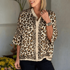 UNTAMED ELEGANCE top featuring a stylish leopard patchwork design, perfect for a comfortable and chic look.