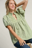 Elegant light sage Umgee top with floral trim and leaf jacquard print, perfect for spring to fall style.