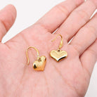 Forever Yours Earrings featuring heart-shaped drops in polished 18K gold-plated stainless steel, perfect for romantic occasions.