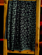 Luxurious leopard print throw blanket in dark charcoal and forest blend, perfect for cozy nights. Size 60x70 inches.