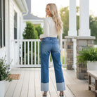 Model showcasing RISEN GIANNA JEANS with wide cuffed hem from behind, emphasizing relaxed fit and stylish design.