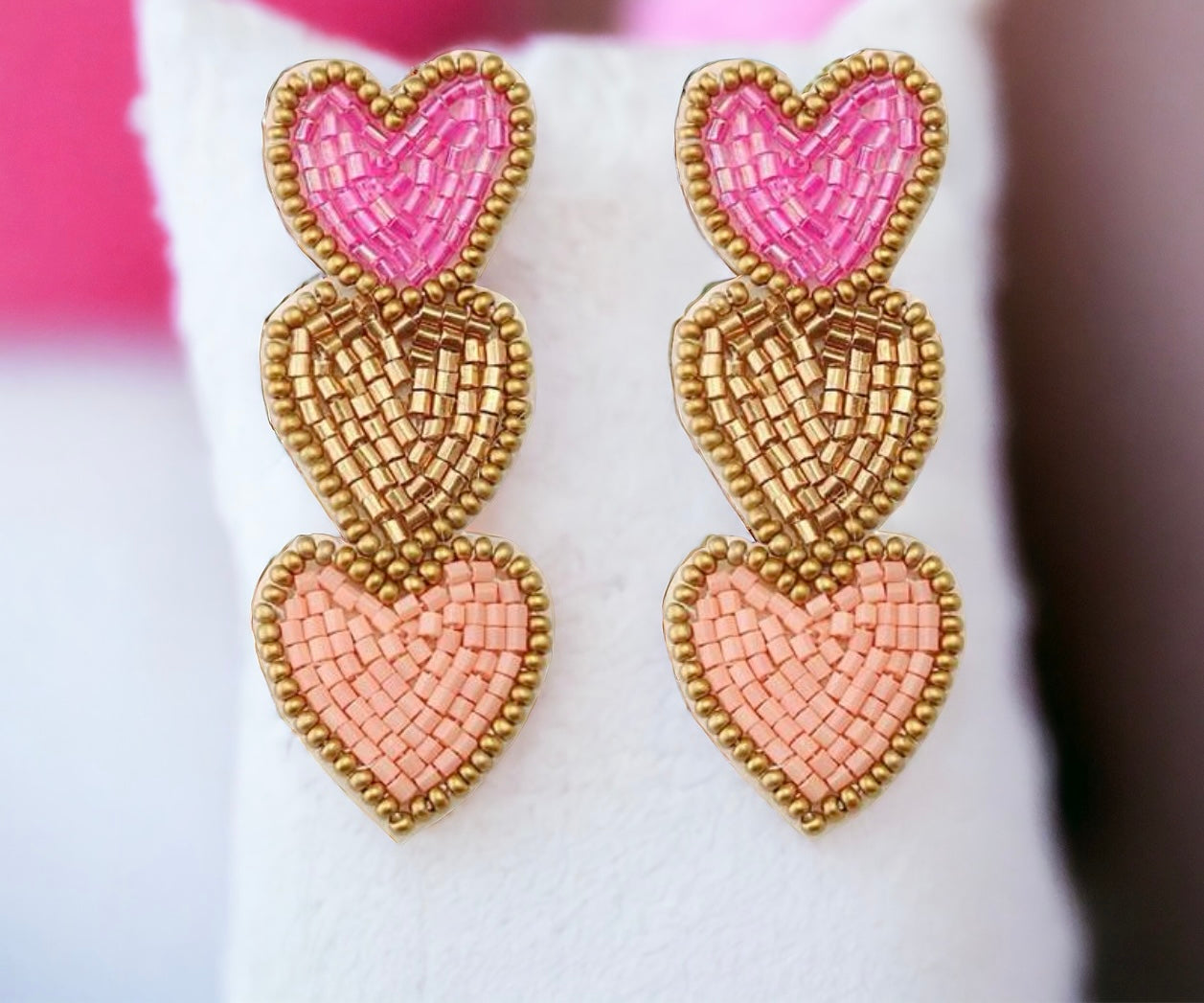 Triple Play earrings with pink and peach beaded hearts for a vibrant fashion statement.