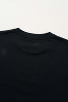 Back view of a black t-shirt showcasing a smooth neckline, ideal for casual styling and everyday wear.