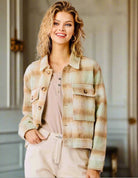 Woman wearing WARM EMBRACE Jacket by Umgee with pistachio and tan plaid design, tortoise shell buttons, and soft flannel fabric.