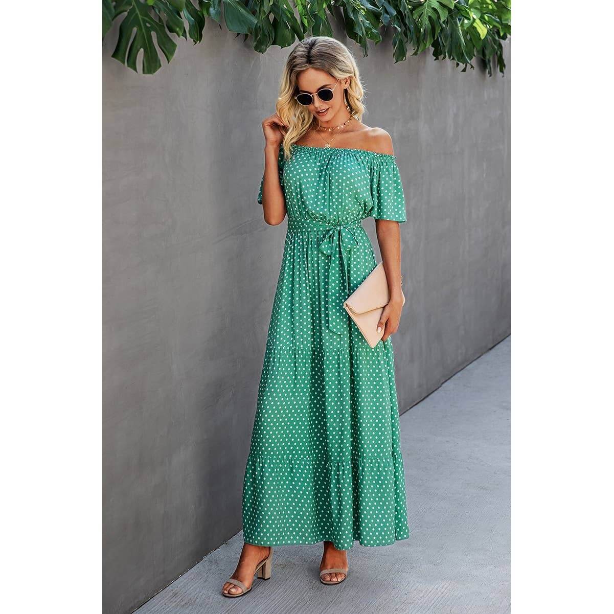 Casual off-shoulder green polka dot maxi dress with a tie waist, perfect for outdoor or vacation styling.