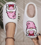 HUGS & HEARTS SLIPPERS featuring fluffy white sherpa and embroidered character in pink hat and pants.
