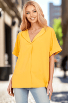 Model wearing a vibrant yellow Morning Honey Top with relaxed sleeves and collared neckline, ideal for casual outings.