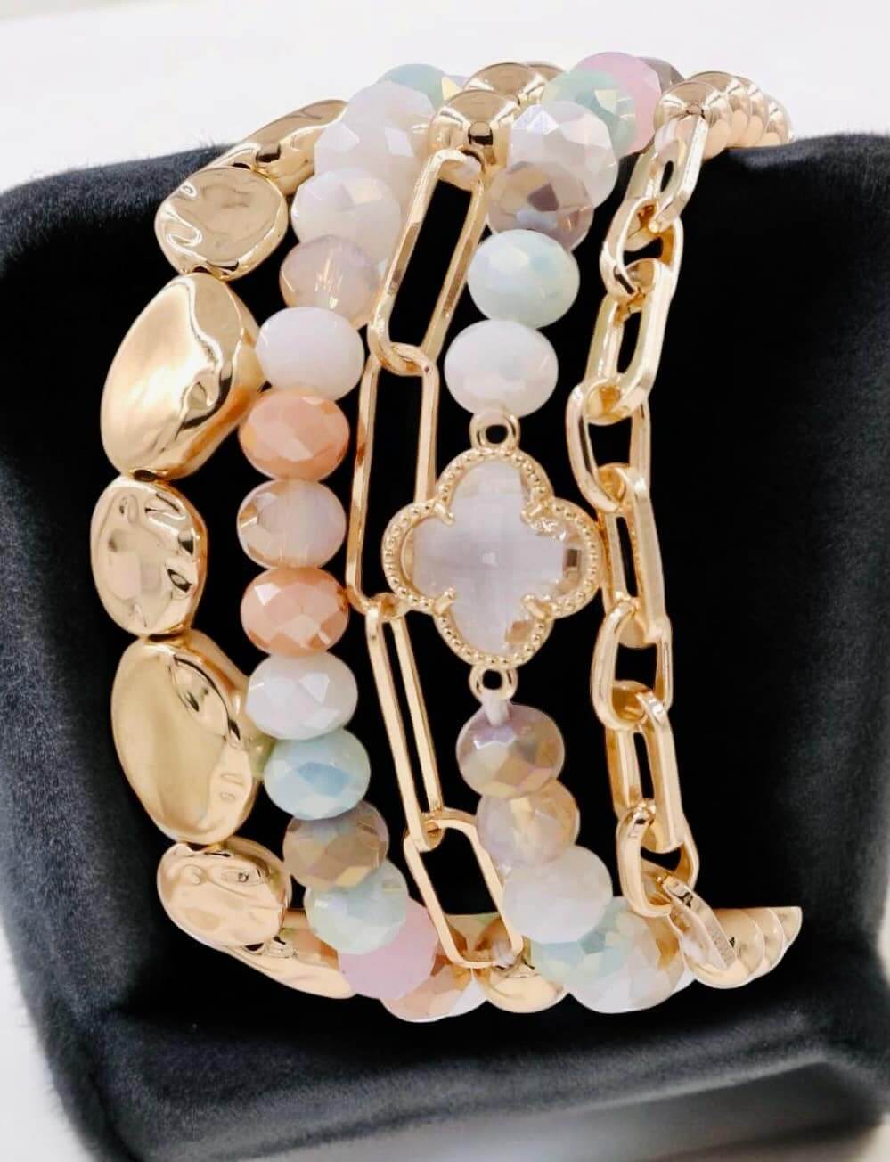 SERENE BRACELET SET in pastels by Nine Jewelry, featuring gold-toned quatrefoil stretch and faceted bead bracelets.