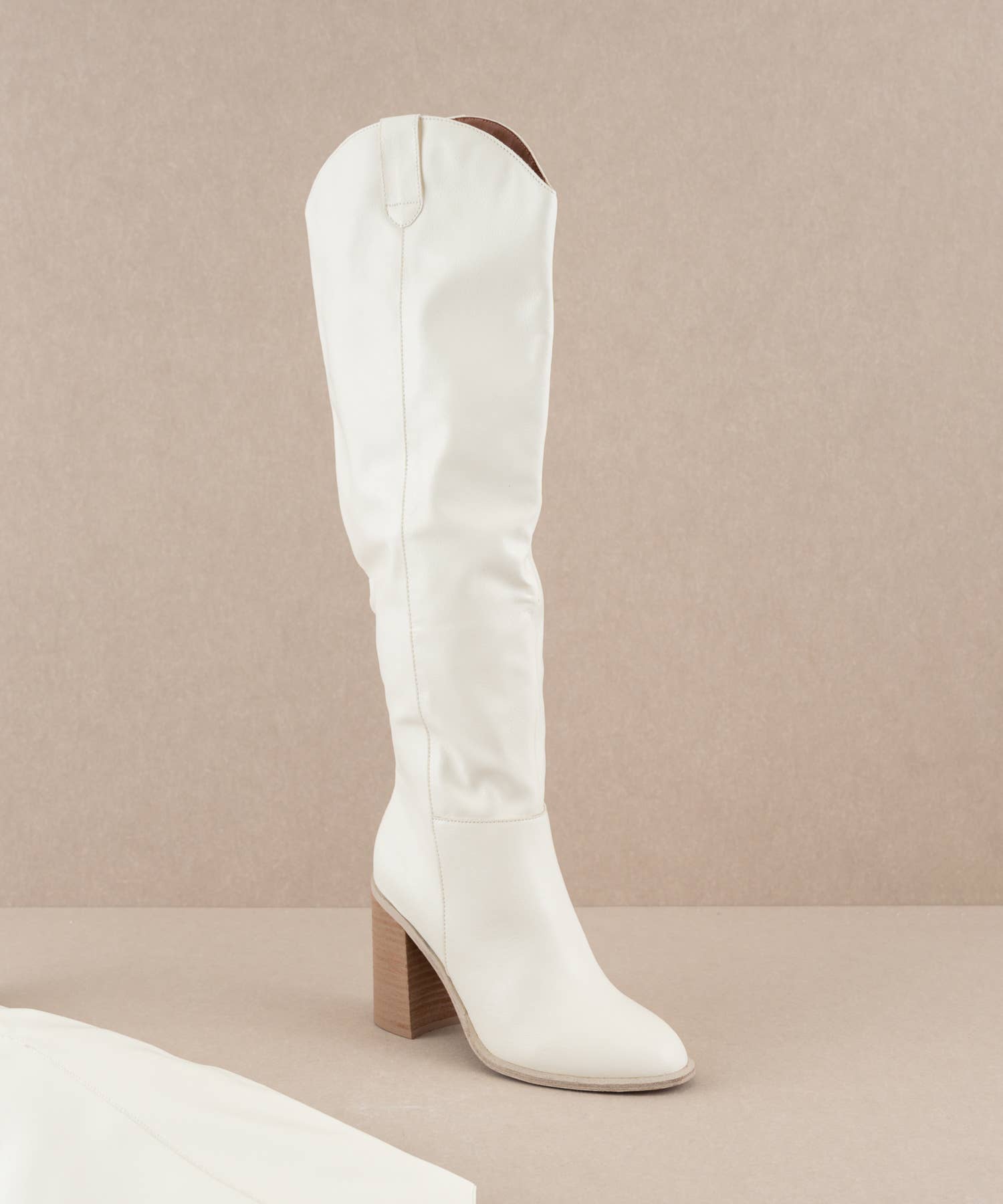 The Stephanie White knee-high boots by Oasis Society with a high heel, perfect for fashion-forward cowgirls.