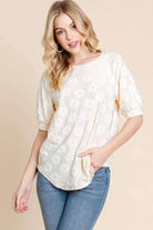 Field of Daisies Top in cream, featuring puff sleeves and textured flower embroidery for a feminine spring style.