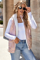 Model wearing the REVERSIBLE RETREAT VEST! showcasing its pink sherpa lining and quilted exterior.