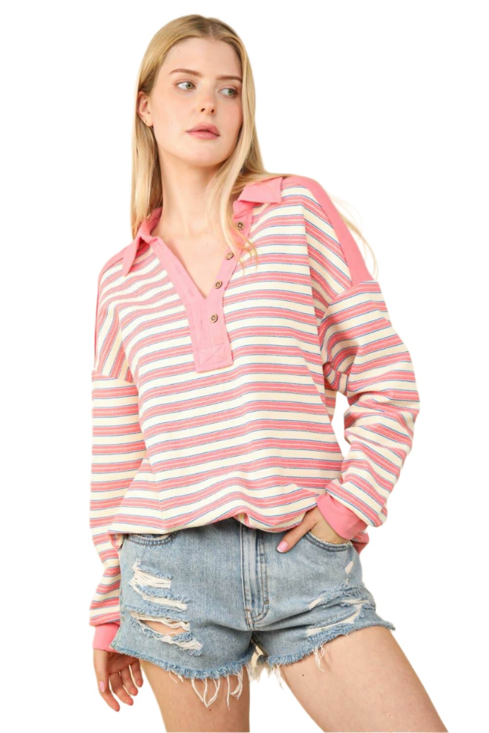 Oversized casual striped knit top in pink and white, featuring a collared design and worn with distressed denim shorts.