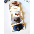LOVE YOU MORE HAIR CLIPS in five matte neutral shades displayed on a stylish wave rack.