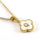 MONOGRAM MOMENTS NECKLACE with a gold-plated flower pendant featuring an embossed initial in the center.
