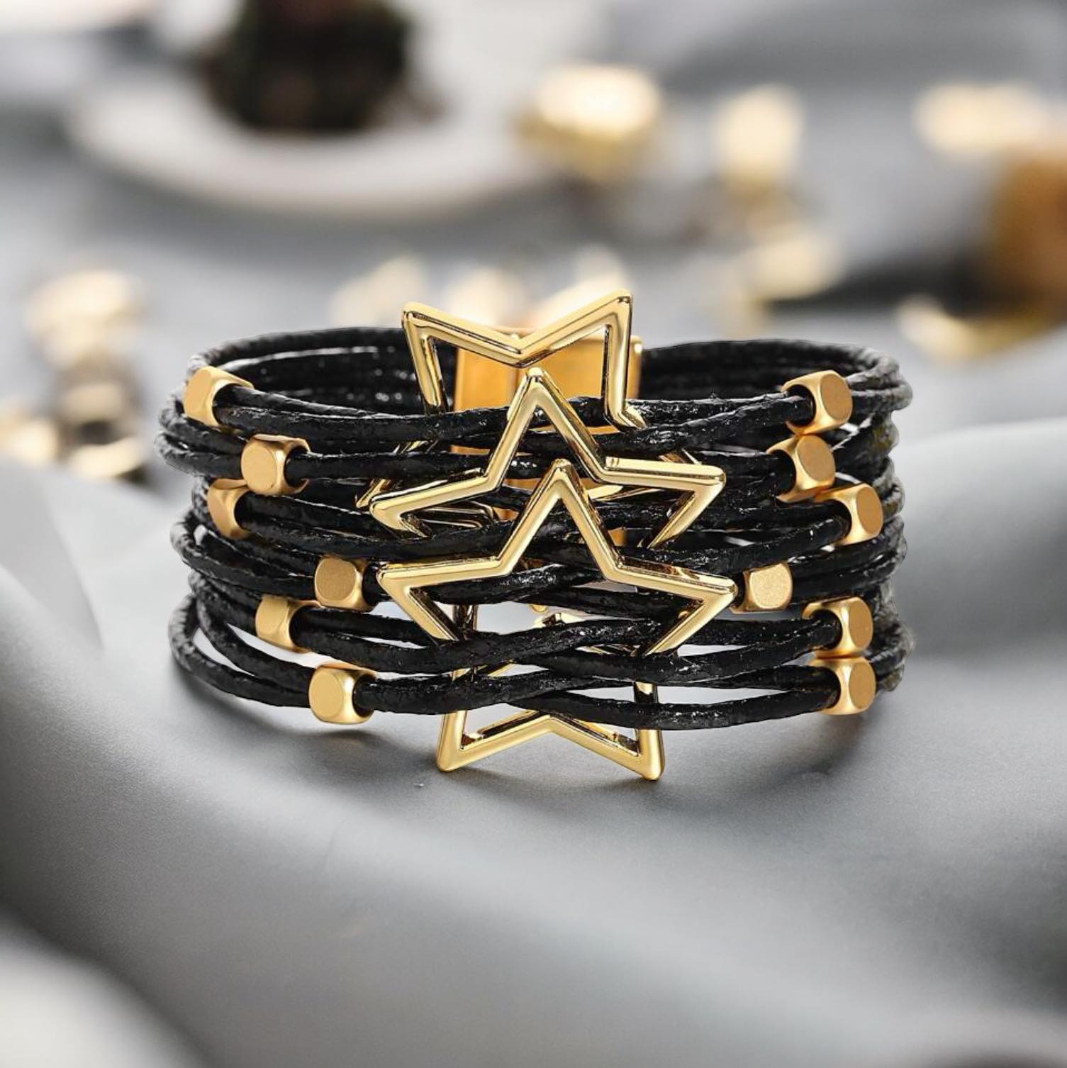 LUCKY STARS Bracelet by Teal Tiger Boutique $14.00 Elegant black woven bracelet featuring a magnetic clasp and a stunning gold colored star design. Teal Tiger Boutique