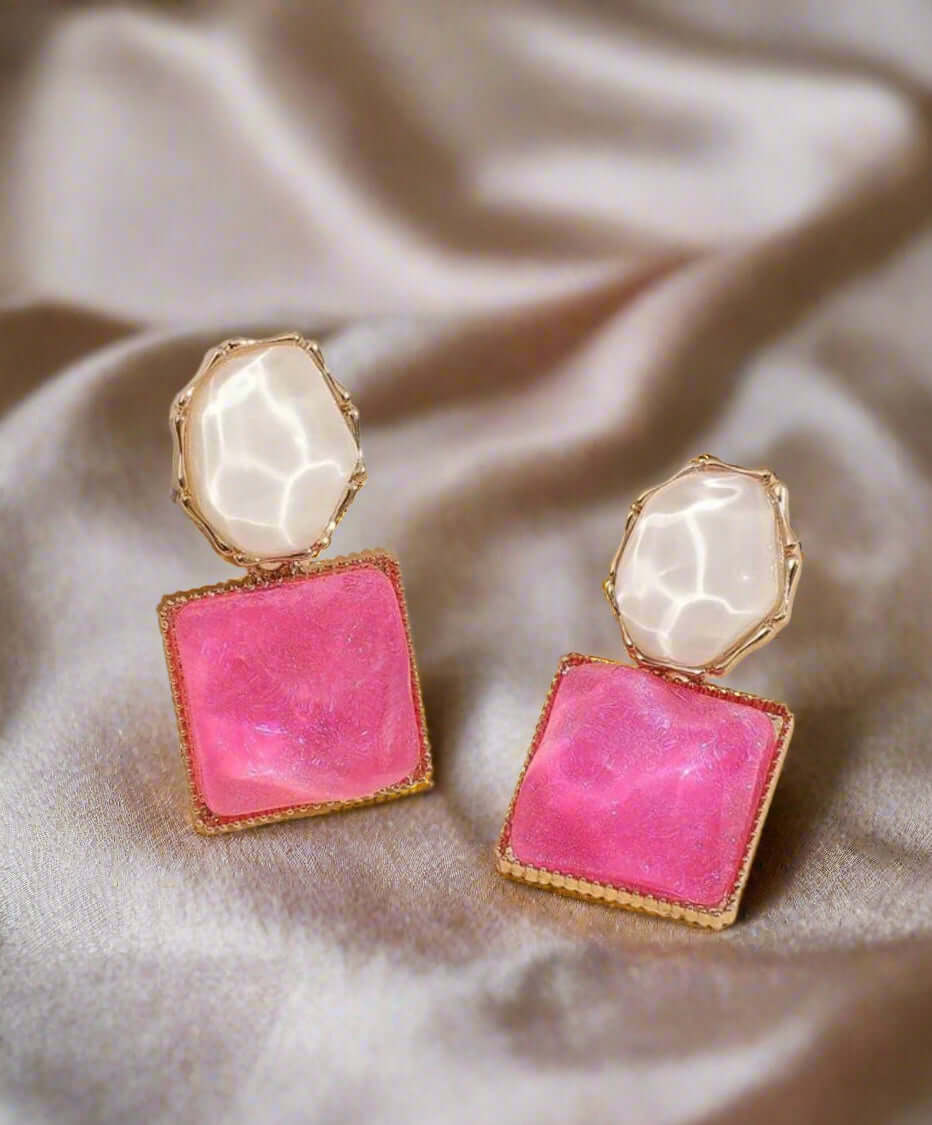 Glazed gem tone earrings featuring pink square stones and white marbled studs in gold-toned settings.