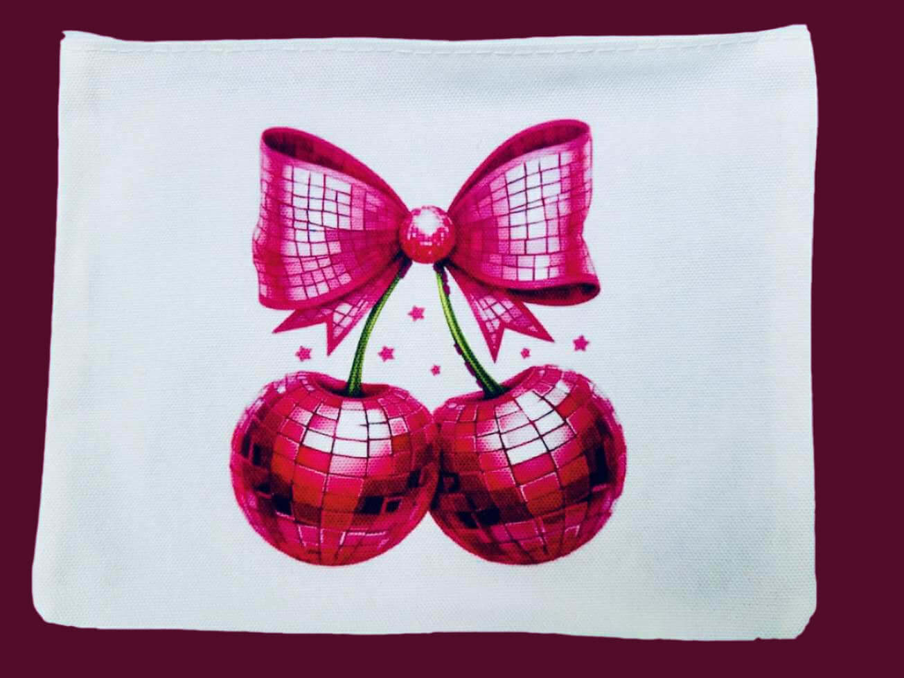 Disco Cherries design on a cosmetic bag, featuring hot pink mirror-ball cherries and a festive bow.