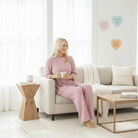 Model wearing CLOUD 9 2 PC PANTS SET, enjoying a cozy moment with coffee in a stylish living room.
