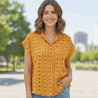 Cheerful yellow button-down blouse with heart motifs, perfect for casual sunny days.