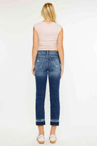 Back view of a model wearing Kancan Georgia Ultra High Rise Slim Straight Leg Jeans in dark wash.