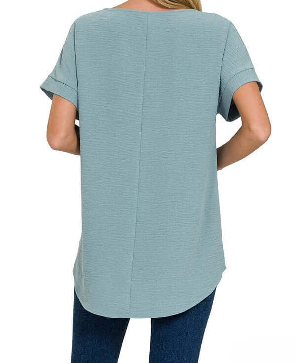 Back view of the dusty blue Air Kiss Top by Zenana featuring a modern high-low hemline and relaxed fit.