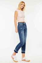 Woman wearing Kancan Georgia Ultra High Rise Slim Straight Leg Jeans with a fitted top and sneakers.