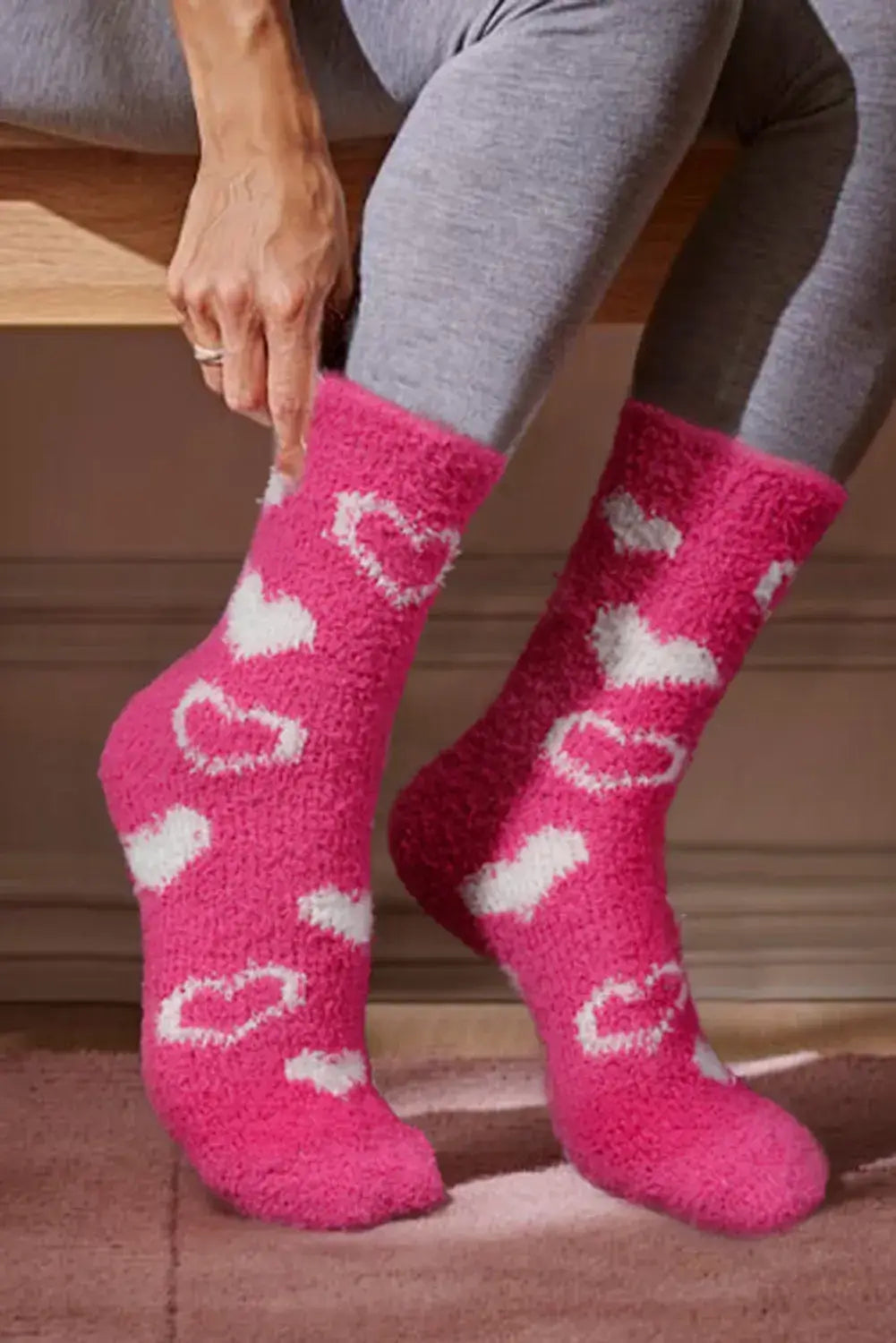 Cozy Heart's Delight Socks in pink with white heart prints, ideal for staying warm and trendy.