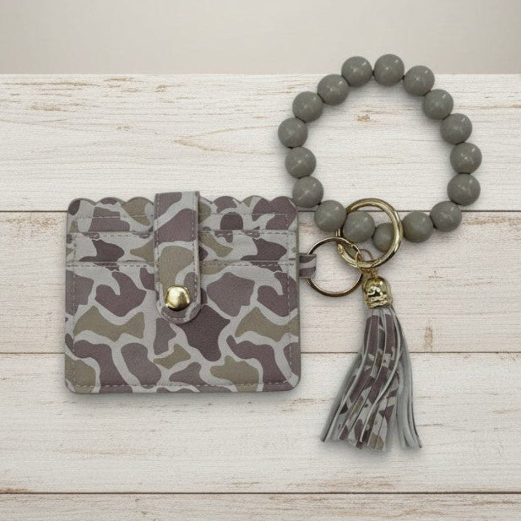LULU MAC CAMO WRISTLET featuring a light camo design, beaded wristlet, and stylish tassel for everyday use.