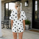 Back view of a woman in MOMENT IN TIME - 2 PIECE SHORTS SET featuring a black and white polka dot print, styled for summer.