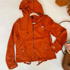 Ginger microfiber suede jacket with hood, perfect for fall fashion, displayed on a flat surface with accessories nearby.