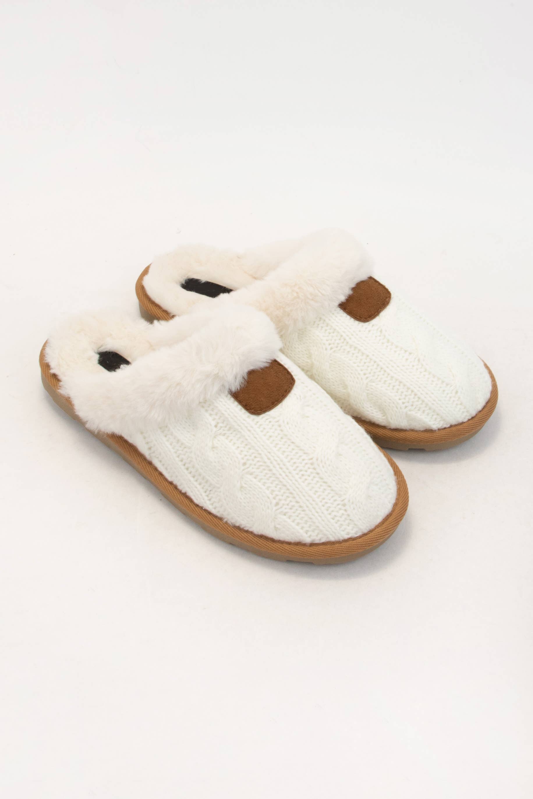 Cozy fur-lined slippers with cable knit upper, perfect for warmth and comfort at home.