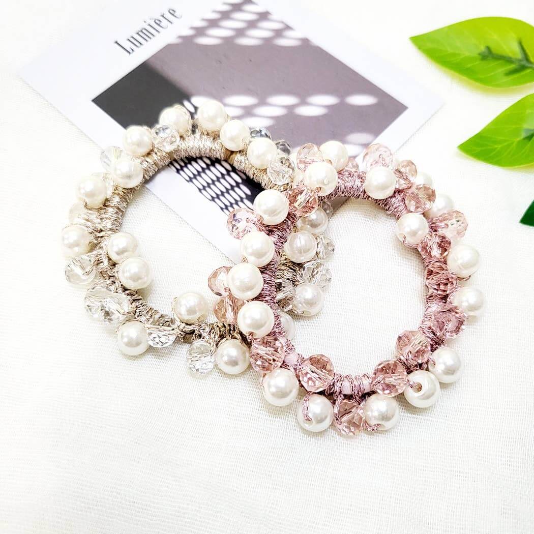 Elegant Charmed Twists hair ties with glass beads and faux pearls in pink and silver.
