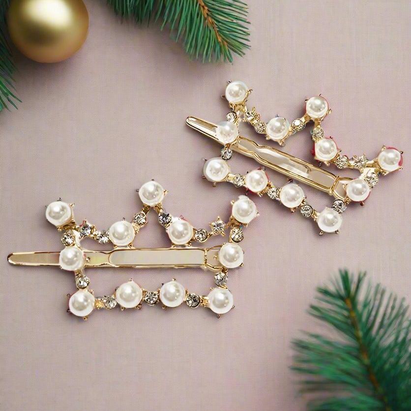 Set of two gold-tone barrettes with faux pearls and rhinestones in crown designs, perfect for holiday styling.