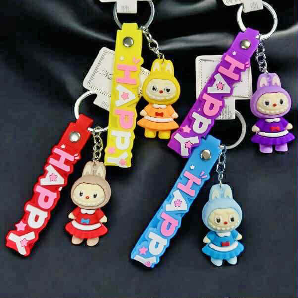 Colorful Labubu keychains in red, yellow, blue, and purple with mini dolls and 'HAPPY' wristlets.
