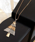 Two tone Christmas tree pendant necklace with star charm, perfect holiday accessory for women’s festive attire.