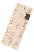 C.C Sherpa Lined Cable Knit Headband in cream color, featuring a cozy design and logo tag for stylish warmth.