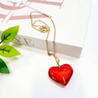 Valentine's Day heart-shaped pendant necklace in red, featuring a gold chain, perfect gift for loved ones.