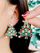 Christmas tree earrings with colored gem stars, adding festive cheer to holiday outfits. Perfect holiday accessory!