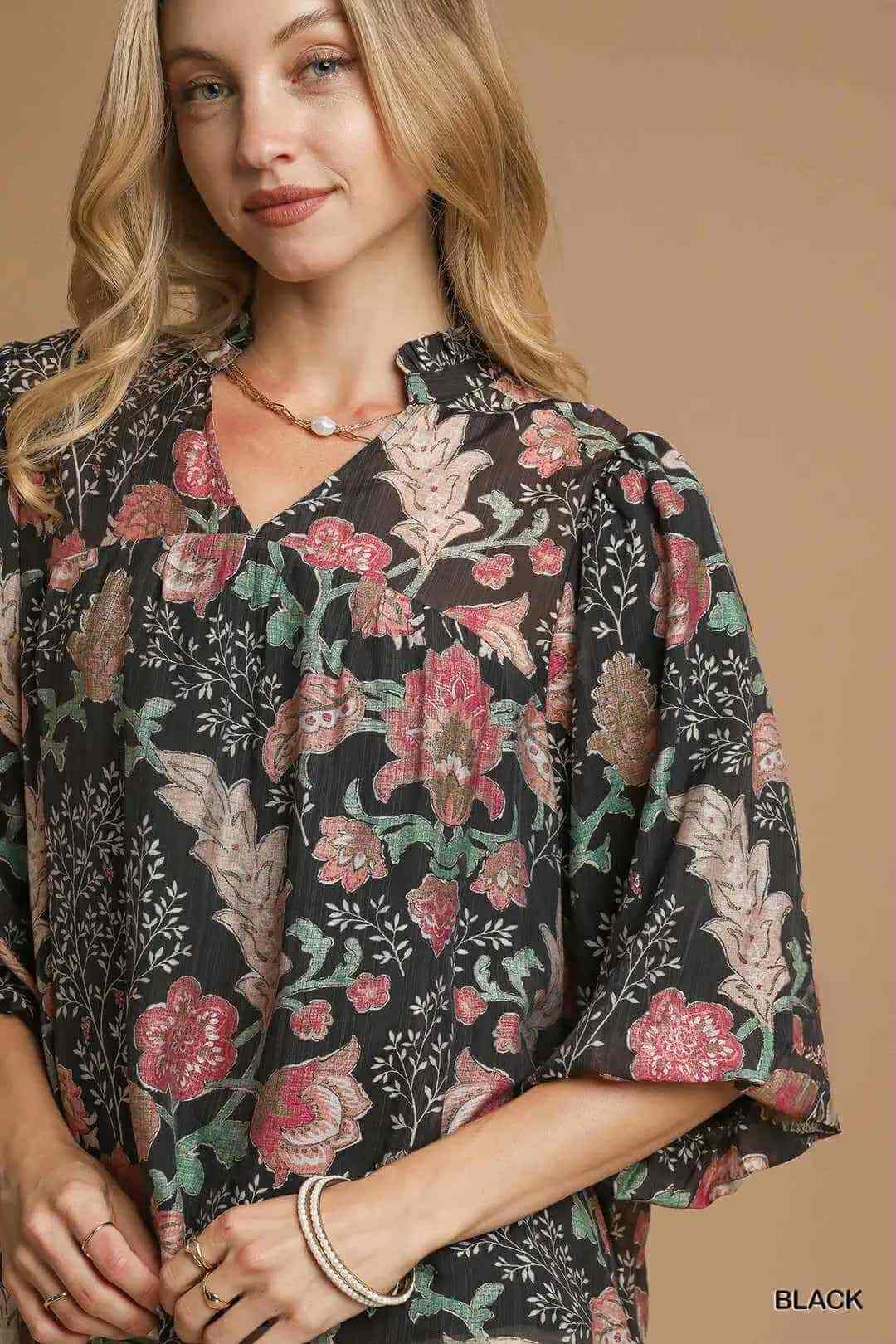 Model wearing FOREVERMORE TOP - Umgee, a floral blouse featuring puff sleeves and a v-neckline, perfect for various occasions.