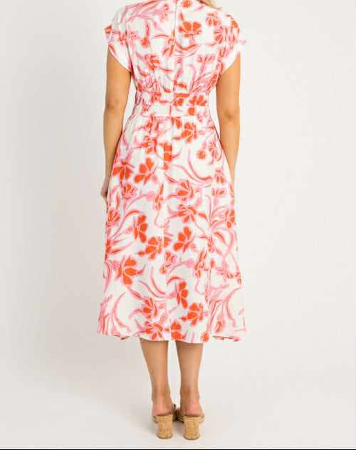 Back view of Papaya Paradise Dress by She + Sky, showcasing vibrant floral print and cinched elastic waist.