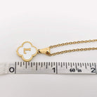 Close-up of MONOGRAM MOMENTS NECKLACE featuring a gold-plated pendant with an initial and delicate chain.