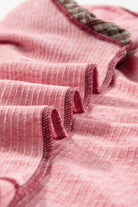 Close-up of pink ribbed Mixed Blessings top showing texture and unique mixed print sleeve with patchwork bubble design.