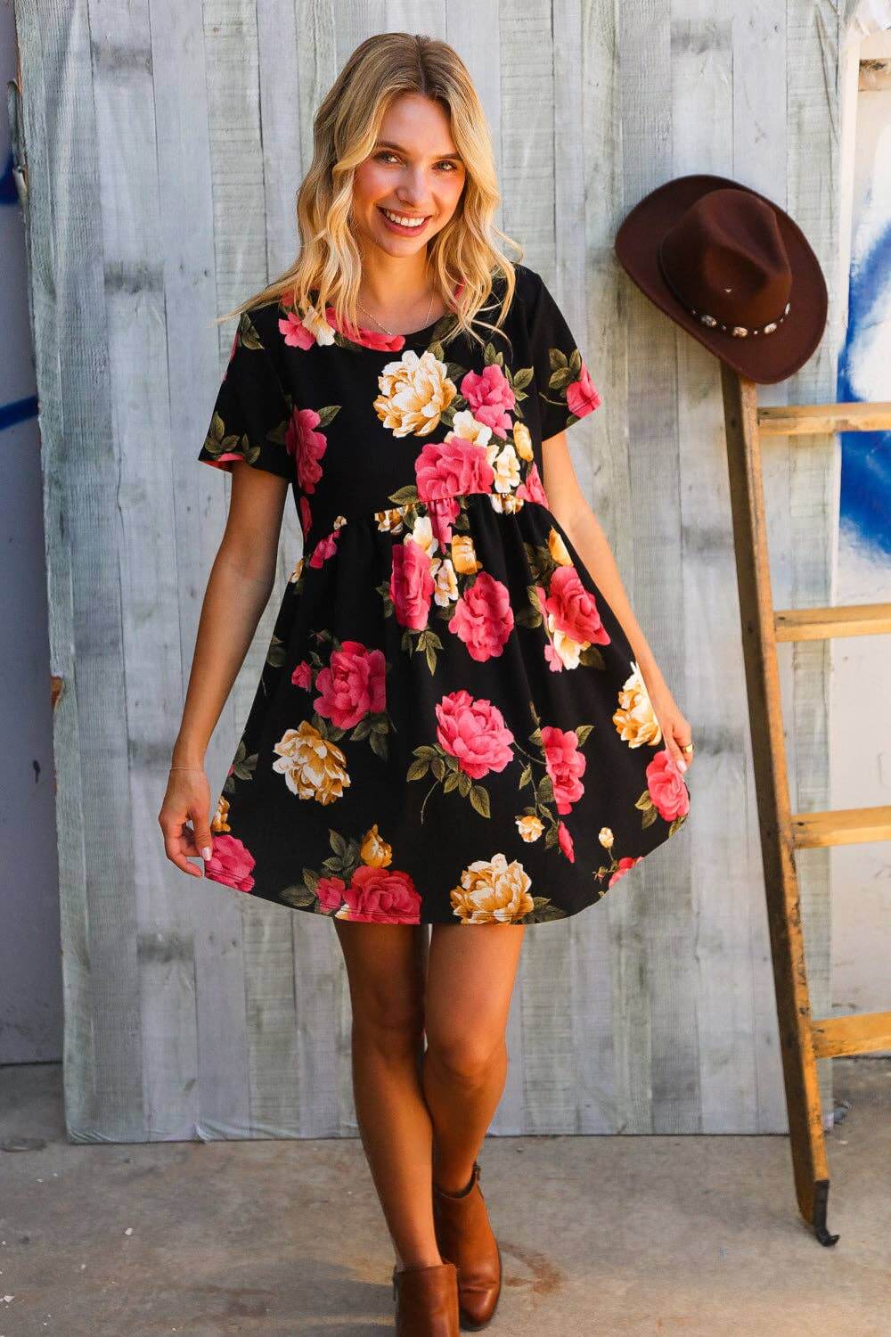 Model wearing the Twilight Garden Party Dress featuring vibrant floral patterns against a black background.