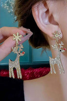 Luxury red nosed reindeer earrings with rhinestones and snowflake design worn on the ear, perfect for holiday festivities.