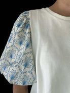 Sky-blue floral puff sleeve on off-white Skylark Sweetness Top by Umgee, perfect blend of comfort and style.