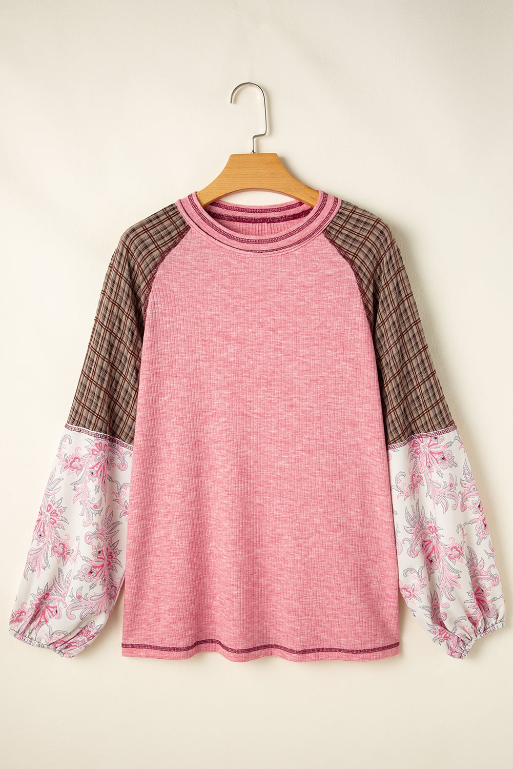 Mixed Blessings Top with pink ribbed fabric, patchwork bubble sleeves in brown checkered and floral print, on a hanger.