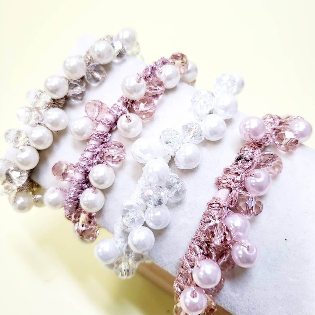 Elegant Charmed Twists hair ties with glass beads and faux pearls in soft pastel colors.