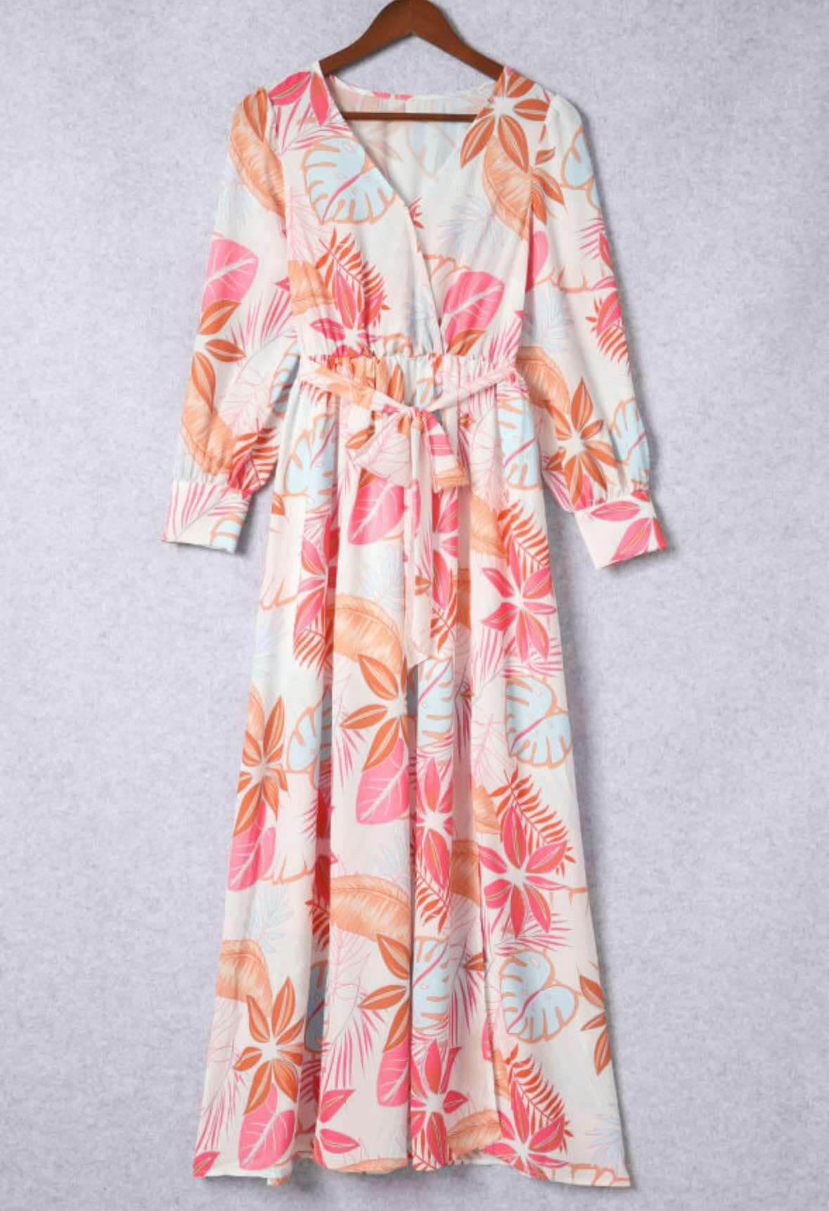 Tropical Sensation Dress with floral patterns, high slit and wrap design, perfect for beach vacations and garden parties.