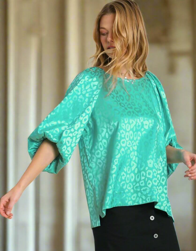 Teal satin top with puff sleeves and leopard print by Umgee, featuring trendy side slits for a sophisticated and comfortable look.