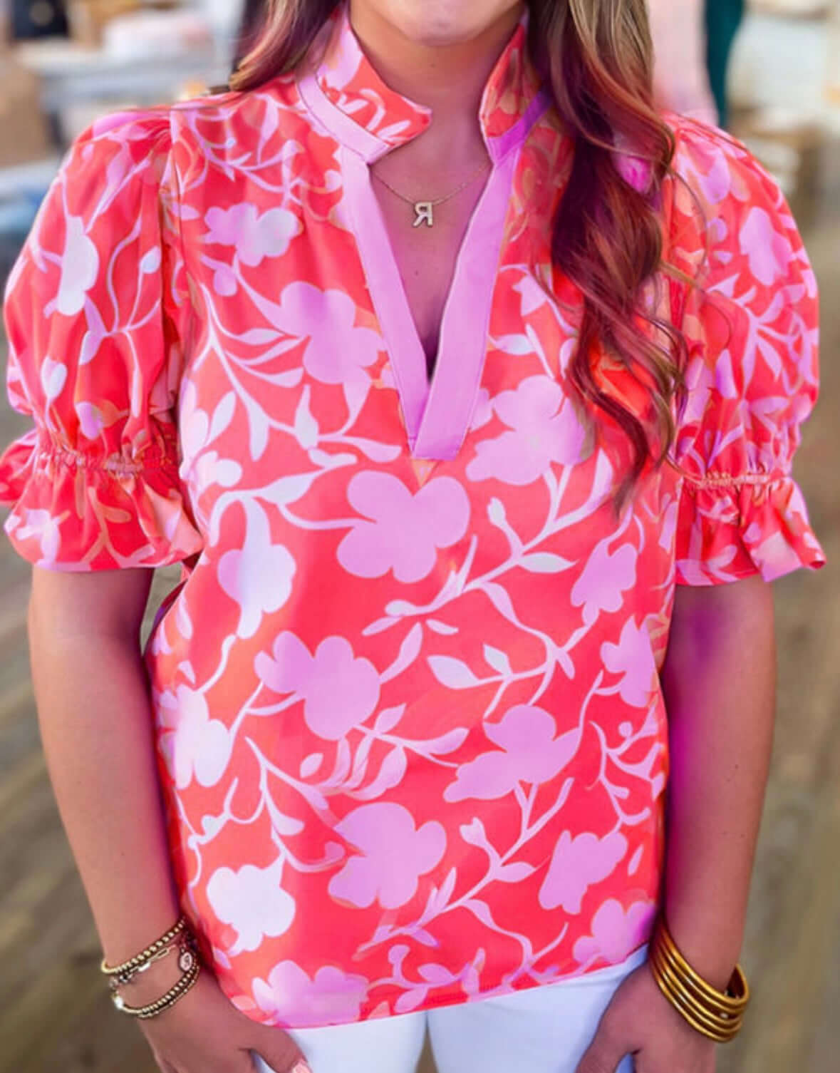 Bright floral print top with puff sleeves, perfect for summer styling. Ideal for casual or dressy occasions.